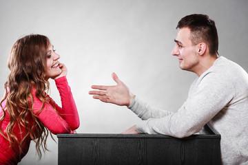 Man trying to reconcile with woman after quarrel.