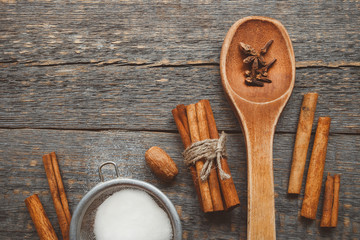 Cinnamon sticks, a sieve with a spoon of sugar and spice