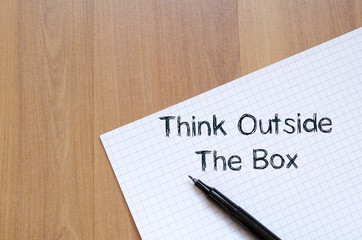 Think outside the box write on notebook