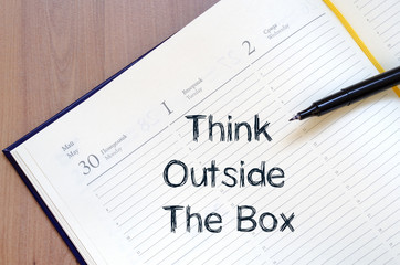 Think outside the box write on notebook