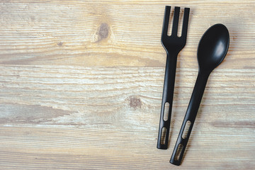 Spoon and fork on a wooden board