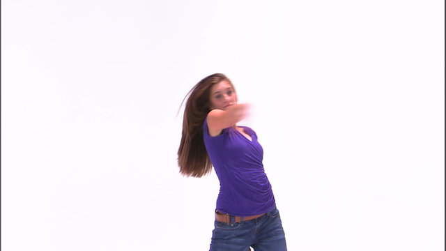 Clip of a girl in a purple shirt dancing on a white background.