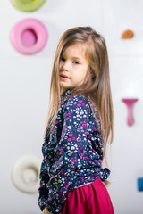 The little girl posing in a playroom