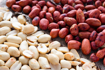 background of crude and refined roasted peanuts