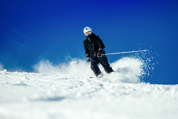 Male skier skiing at ski resort