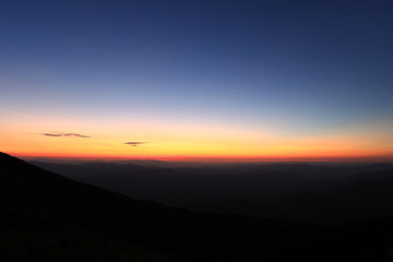 colorful sky above mountain just before sunrise
