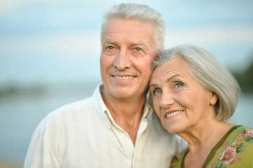 Happy senior couple  near river