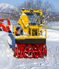 Yellow tractor for snow removal