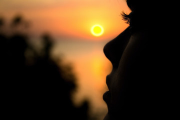 silhouette of a young woman at sunset