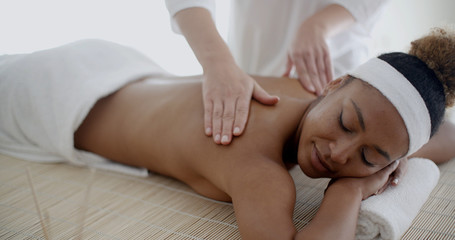 Fototapeta na wymiar Female therapist's hands doing back massage on woman