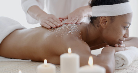 Obraz na płótnie Canvas Woman getting a salt scrub treatment in the health spa