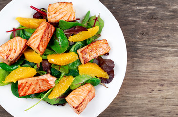 Fresh Salmon Salad with vegetables and orange.