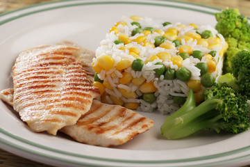Grilled chicken meat with rice and vegetables
