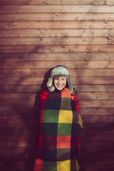 Naklejka premium Young woman resting outdoor, posing under a warm blanket