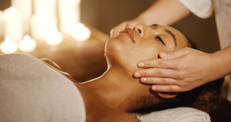 Relaxing woman having a massage for her skin on a face in salon