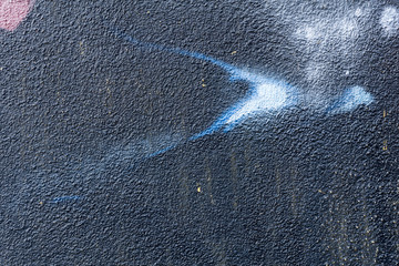 Detail of a graffiti art on a wall. Wall painted in different colors. Abstract dark blue background. © msnobody