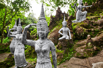 Fototapeta na wymiar Thailand. Amphitheater Of Human And Deities Stone Statues In Buddha Magic Garden Or Secret Buddha Garden In Koh Samui Island. Place For Relaxation And Meditation. Buddhism. Travel To Asia, Tourism. 