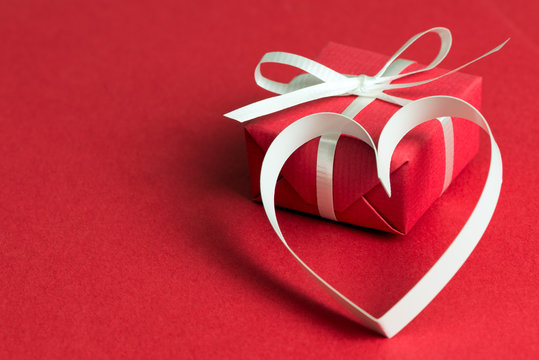 Red gift box with a heart shape symbol