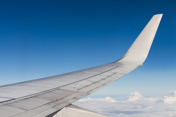 View of an airplane flying above the cloud. Look through the win