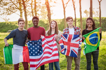 Teenage Friends Holding Flags from different Countries