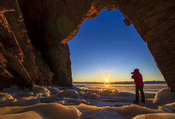 photographer in the grotto and dawn