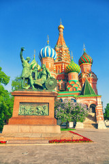 Fototapeta na wymiar Monument to Minin and Pozharsky on the background of St. Basil's Cathedral in Moscow's Red Square, Russia