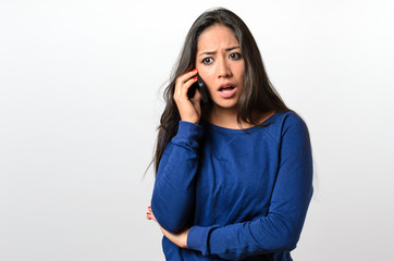 Young woman receiving bad news on her mobile