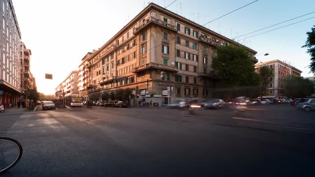 Time-lapse of busy traffic on a street corner in Rome, Italy.
