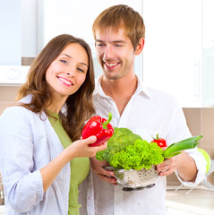 Young couple cooking healthy food at home