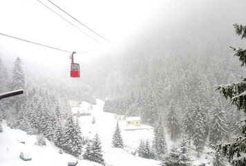 Cable car cabin in mountains while snowing at Transfagarasan, Ro