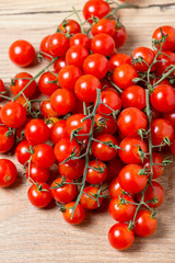 Fresh cherry tomatoes on wooden background