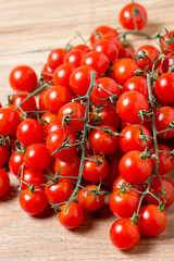 Fresh cherry tomatoes on wooden background