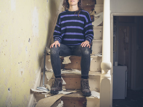 Young woman renovating staircase