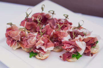 Beautifully decorated banquet catering prepared table with different food snacks and appetizers with sandwich, caviar, fresh fruits on corporate christmas birthday party event or wedding celebration 