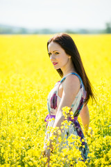 Young woman in rapeseed field