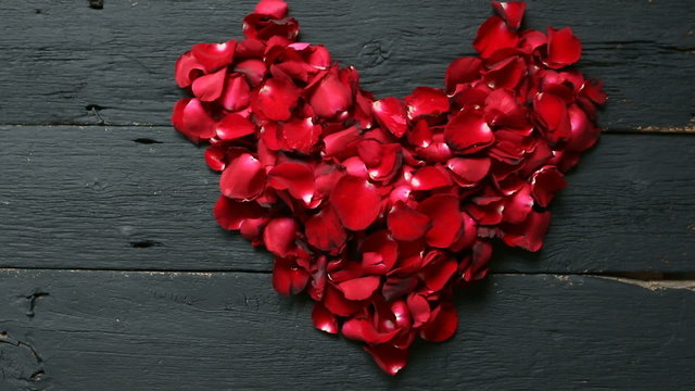 Valentines Day Heart Made of Red Roses petals on black background