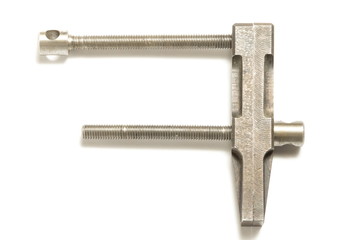 Old clamp tool on white background