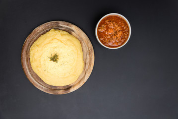 A view from the top of a traditional Polenta with bolognese (ragu) soup on a blackboard surface.