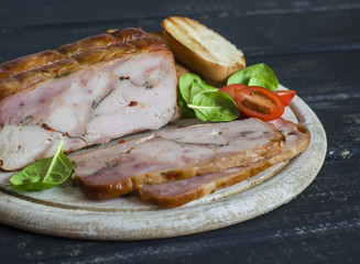 Homemade turkey ham on a light wooden board. Delicious food