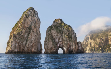 Fototapeta premium Amazing landscape at Capri Island with Faraglioni - coastal rocks formation at the Mediterranean Sea.