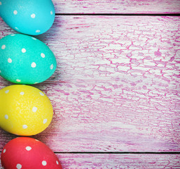 Easter eggs on pink wooden background