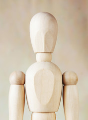 Wooden dummy against brown background