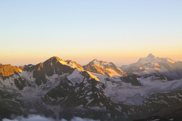 Fototapeta na wymiar Panorama of mountain peaks in the setting sun, the majesty and b