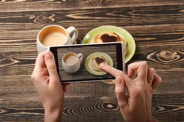 Hands taking photo pancakes with smartphone