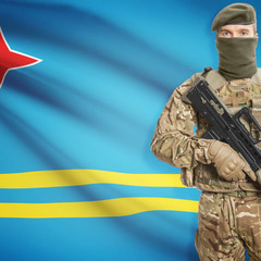 Soldier with machine gun and flag on background - Aruba