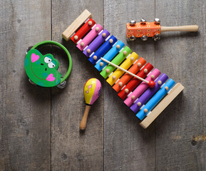 Toy Musical instruments collection on old wooden table