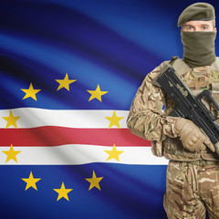 Soldier with machine gun and flag on background - Cape Verde