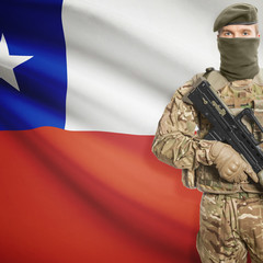 Soldier with machine gun and flag on background - Chile