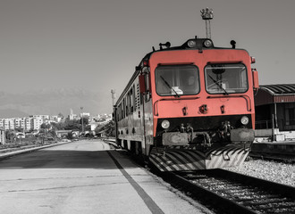 Fototapeta na wymiar Red old train is ready for his journey. / Red old train is waiting on station. City of Split is in background, Croatia.