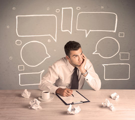 Busy office worker with drawn text bubbles